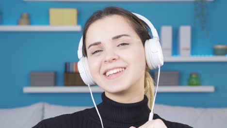 Happy-and-cheerful-young-woman-listening-to-music.